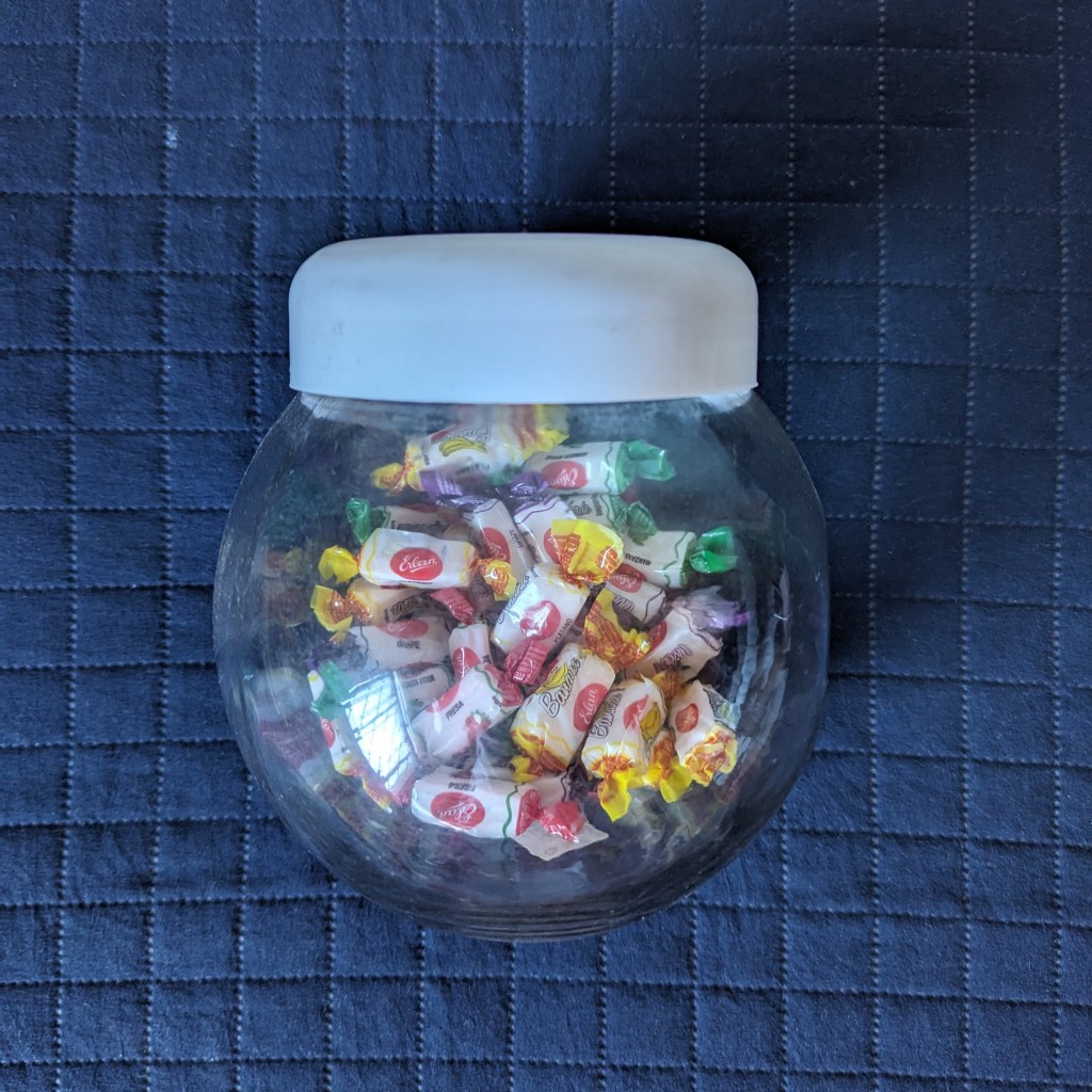 Pote de balas de vidro transparente com balas de vários sabores
